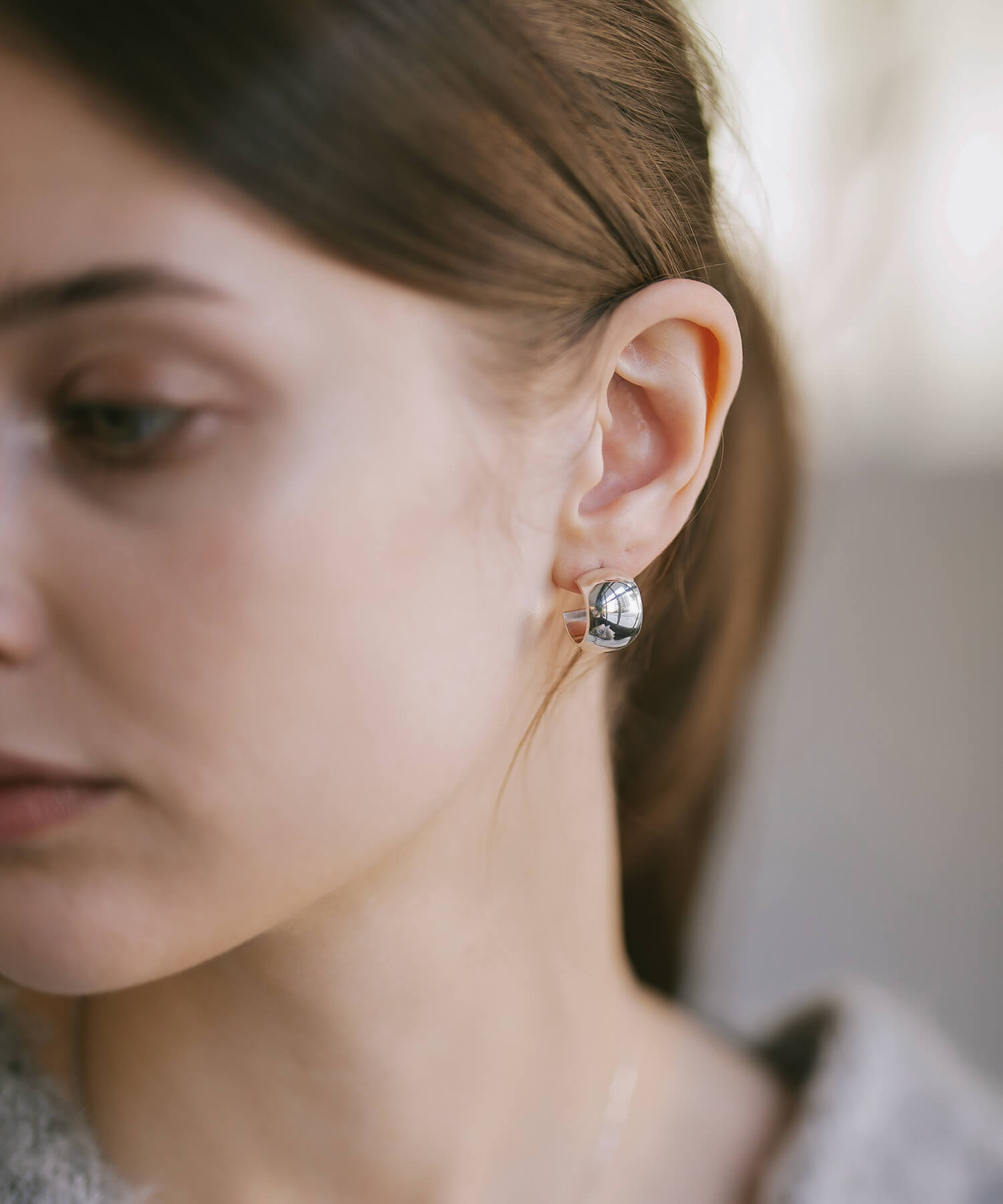 Sterling silver chunky barrel hoop earrings worn, side profile