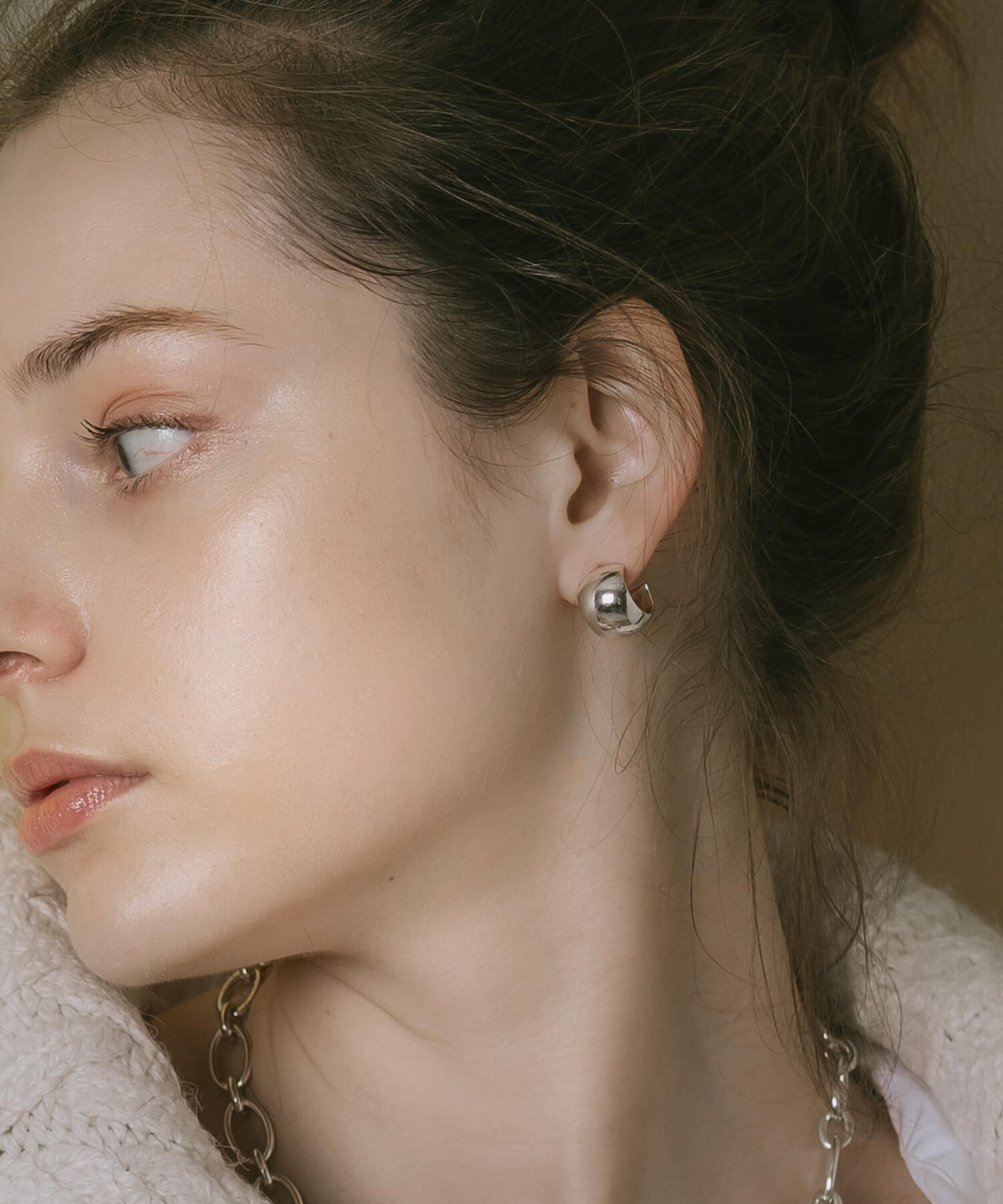 High-polish silver statement earrings, side profile