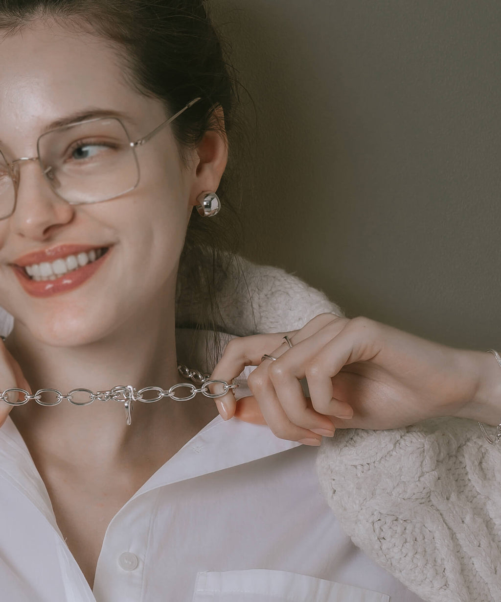 Sterling silver barrel earrings styled with glasses