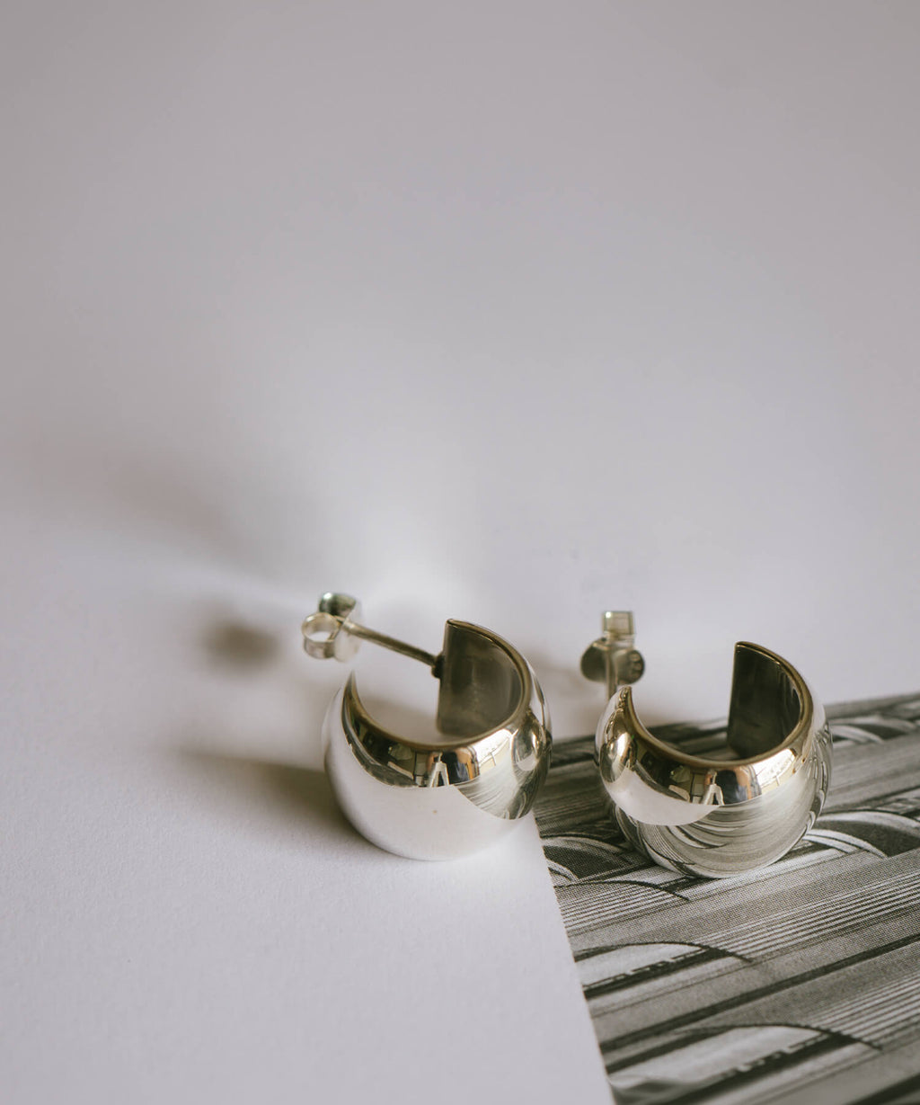 Sterling silver barrel hoop earrings, flat lay