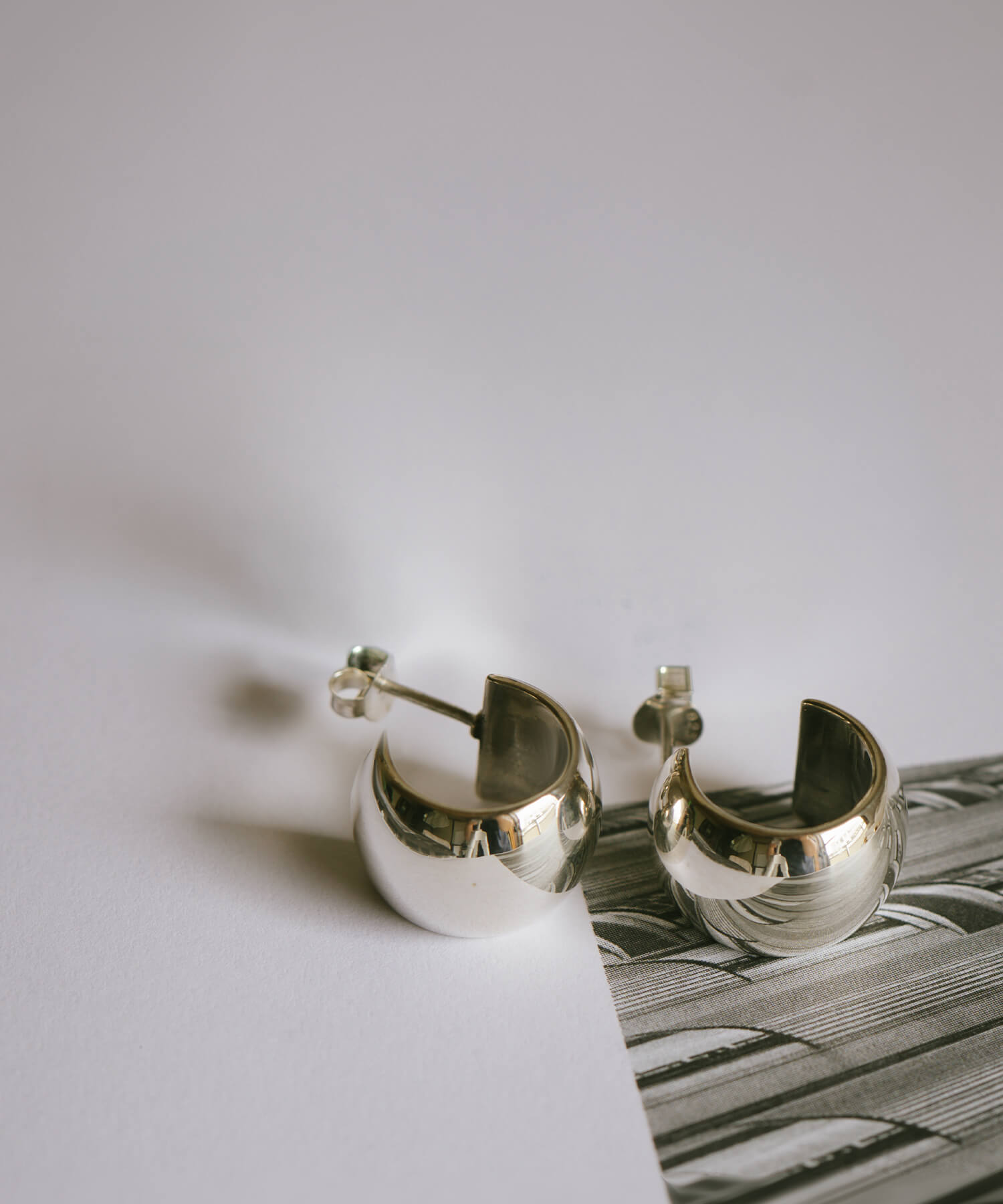 Sterling silver barrel hoop earrings, flat lay