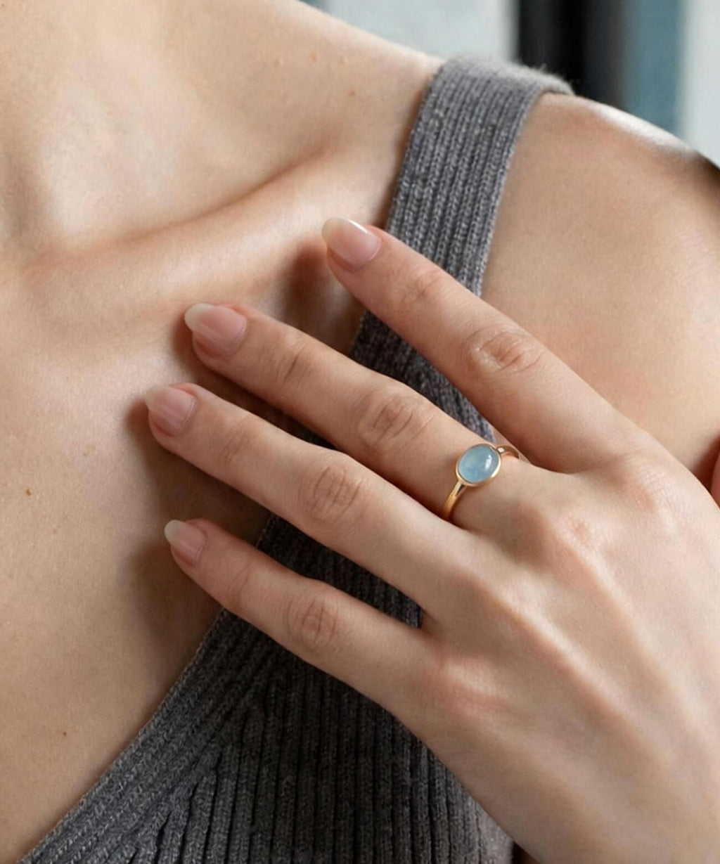 Soft blue gemstone ring on the hand, natural light