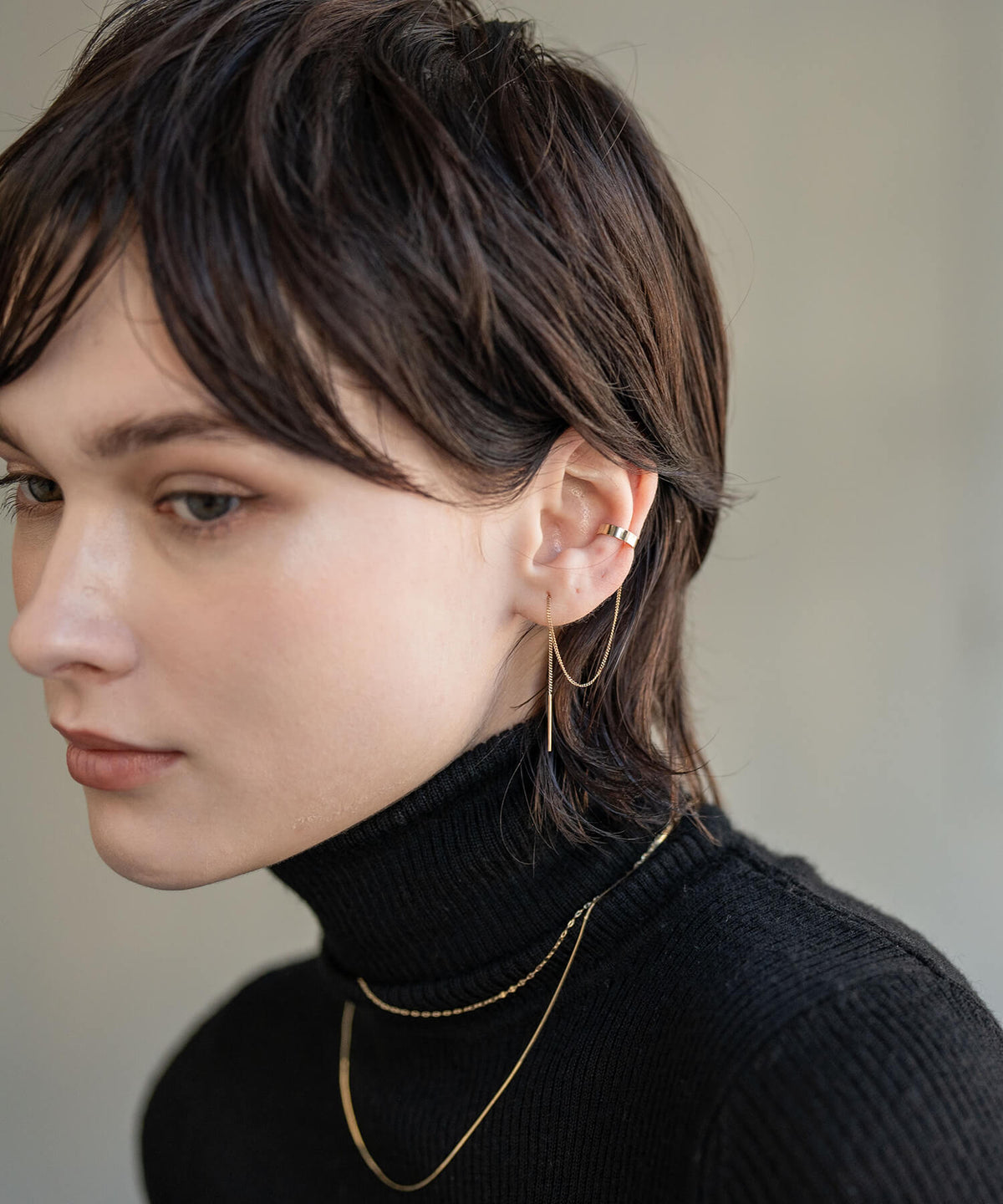 10K gold chain ear cuff seen from behind on a short haircut