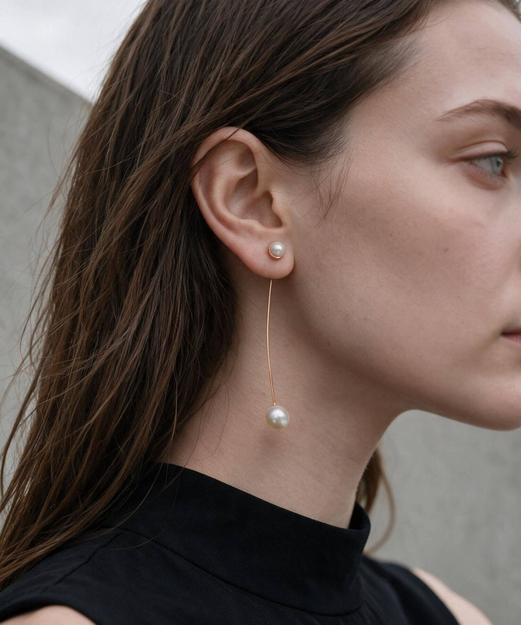 ILMARI pearl earrings worn with black top