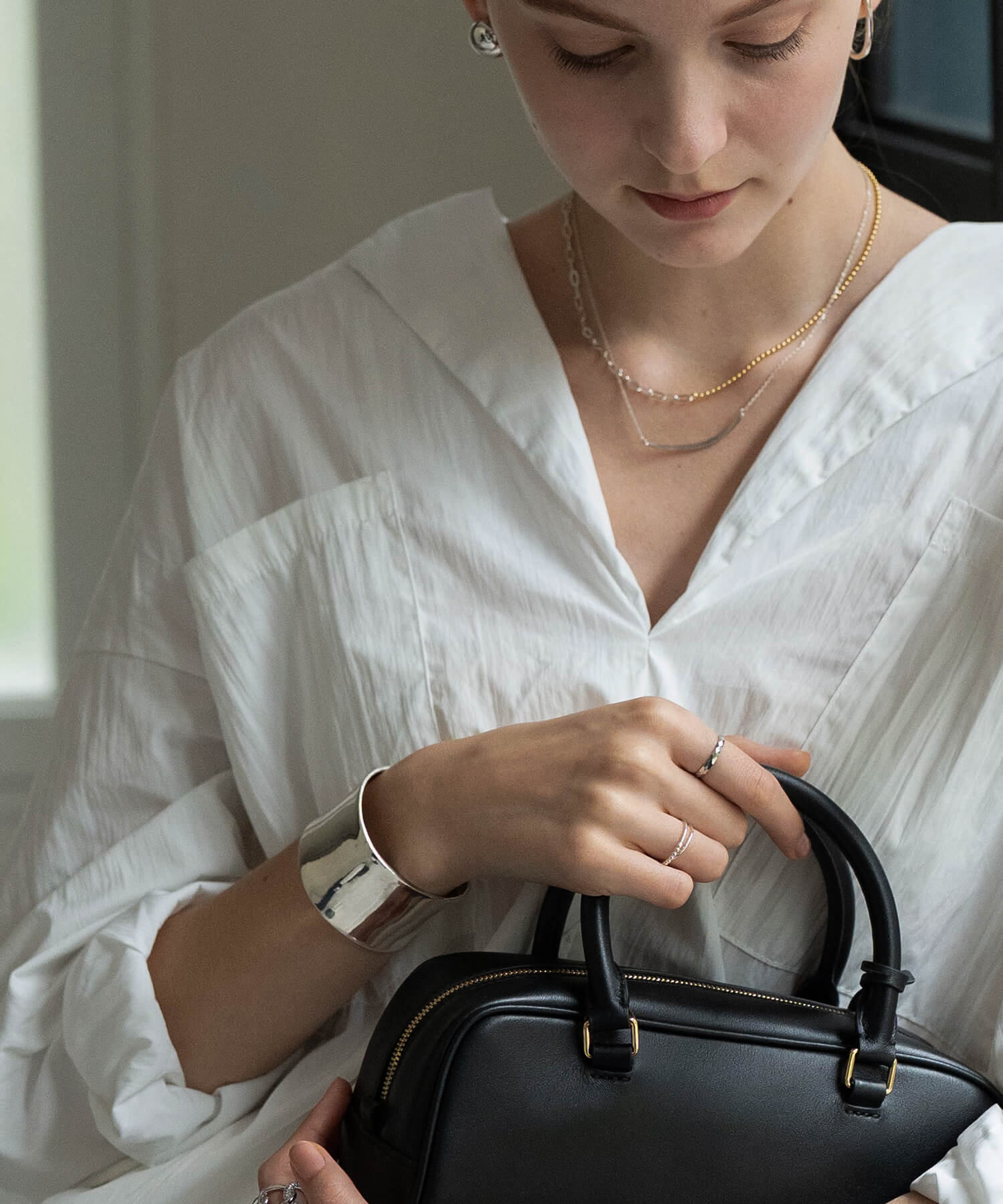 Straight-edge wide silver cuff bangle worn on the wrist