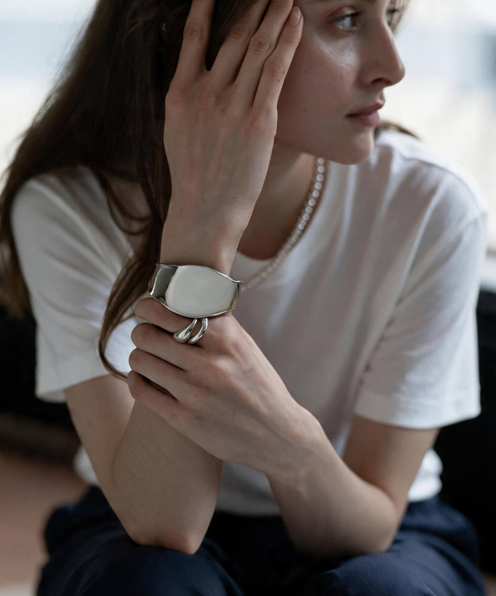 Curved silver 925 cuff bangle on the wrist, side view
