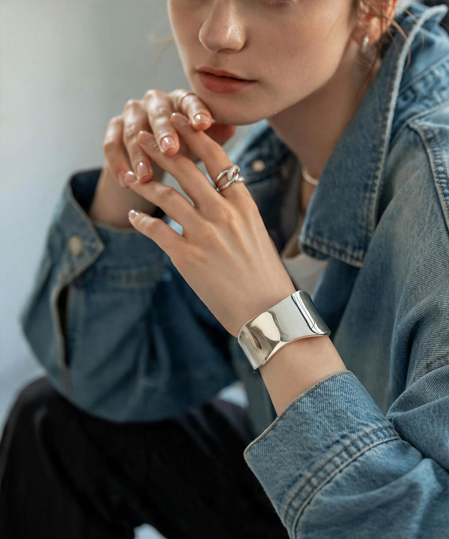 Sculptural wave silver bangle, close-up on the wrist