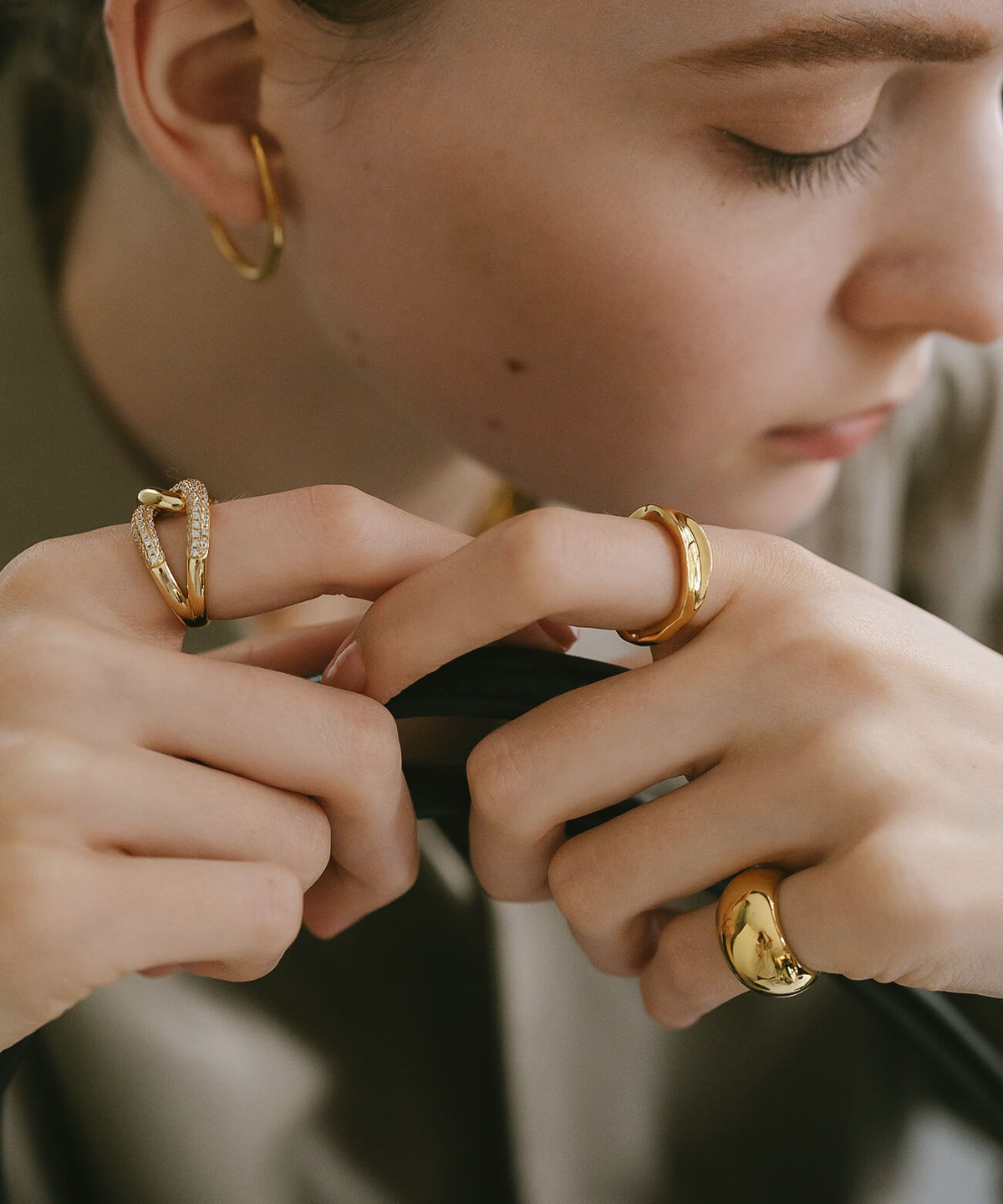 Both hands wearing the 18K gold plated ripple wave ring