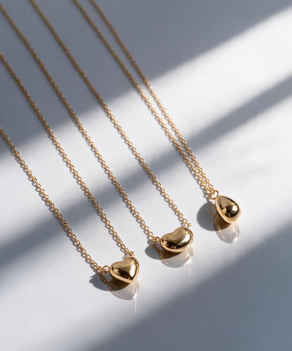 18K gold petit grain necklace styled on a model