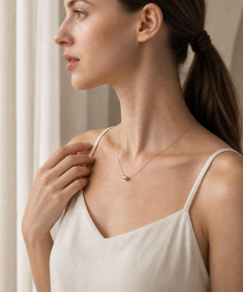 18K gold fave bean pendant on a fine chain