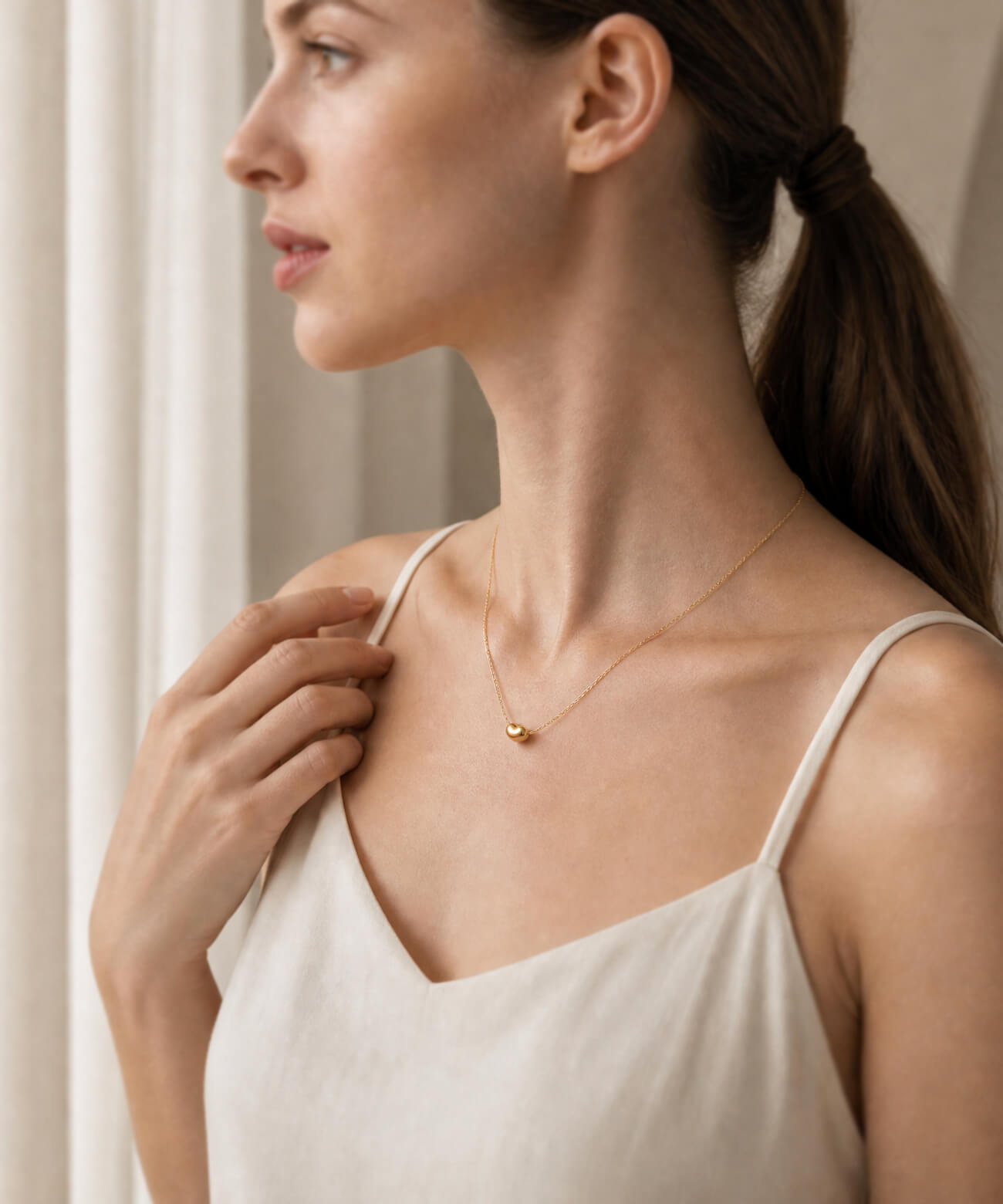 18K gold fave bean pendant on a fine chain