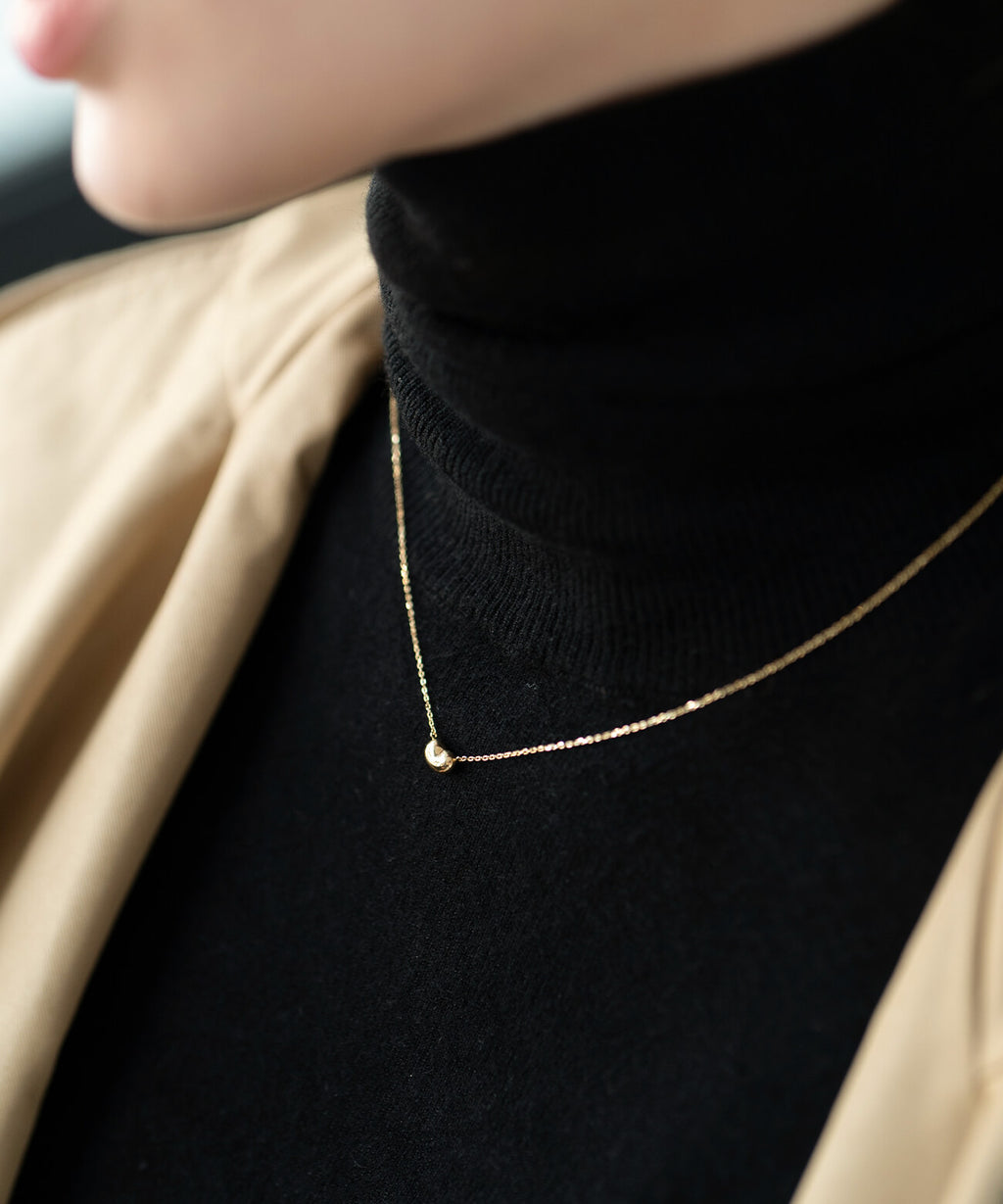 18K gold fave bean pendant necklace styled on a model