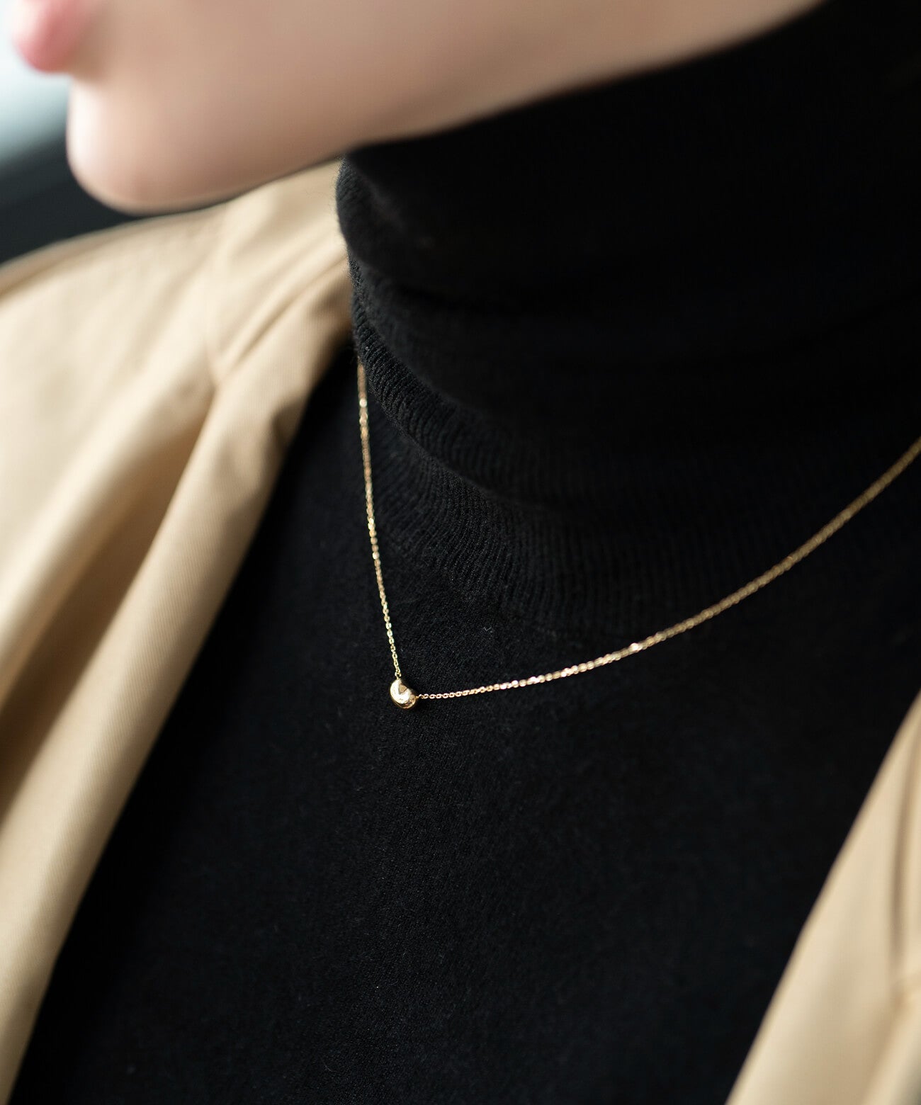 18K gold fave bean pendant necklace styled on a model