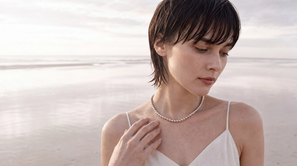 Sterling silver ball chain necklace worn with a camisole by the sea