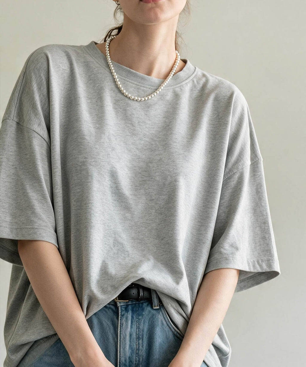 Sterling silver ball chain necklace with a grey T-shirt