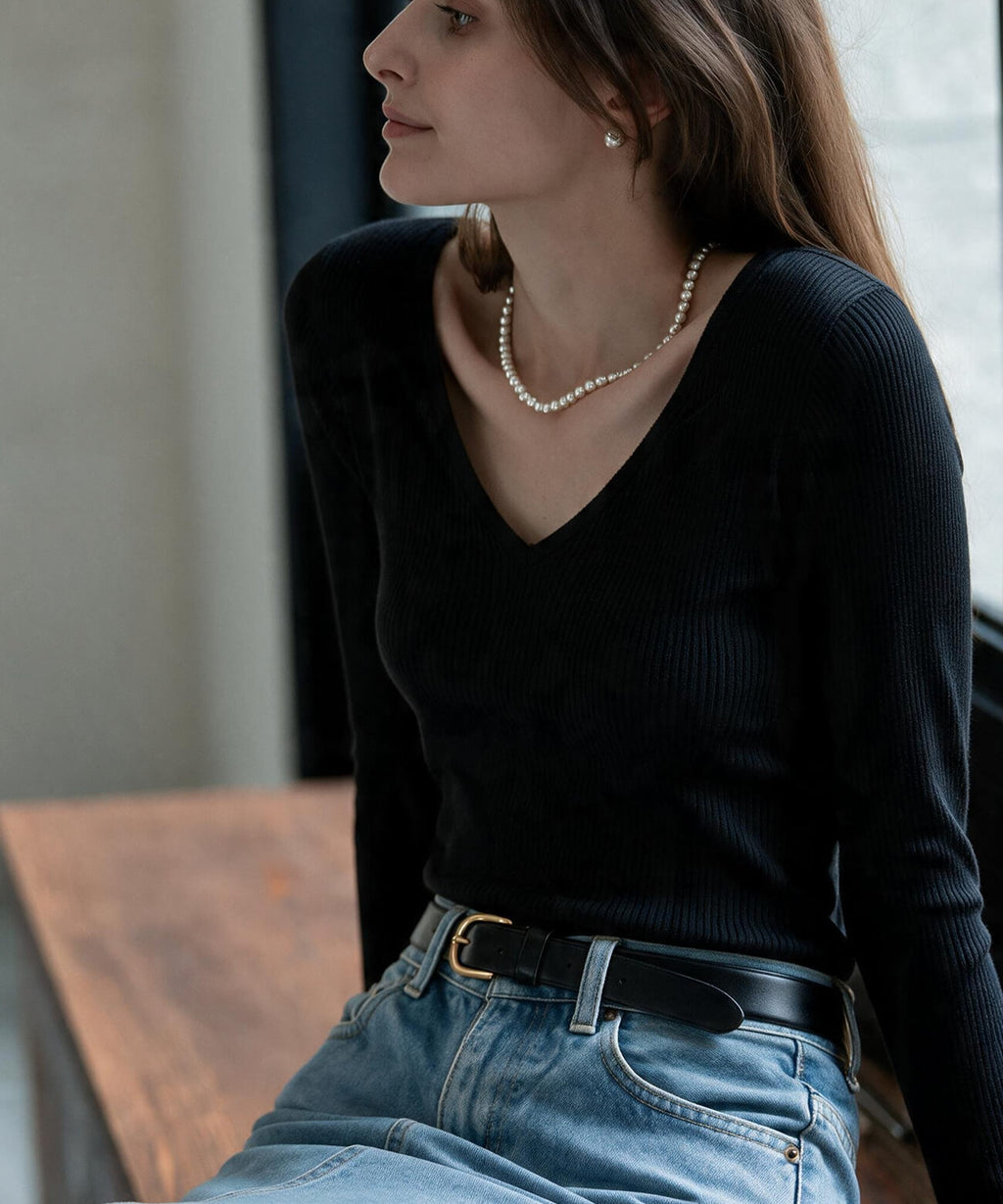 Sterling silver ball chain necklace with a black knit top
