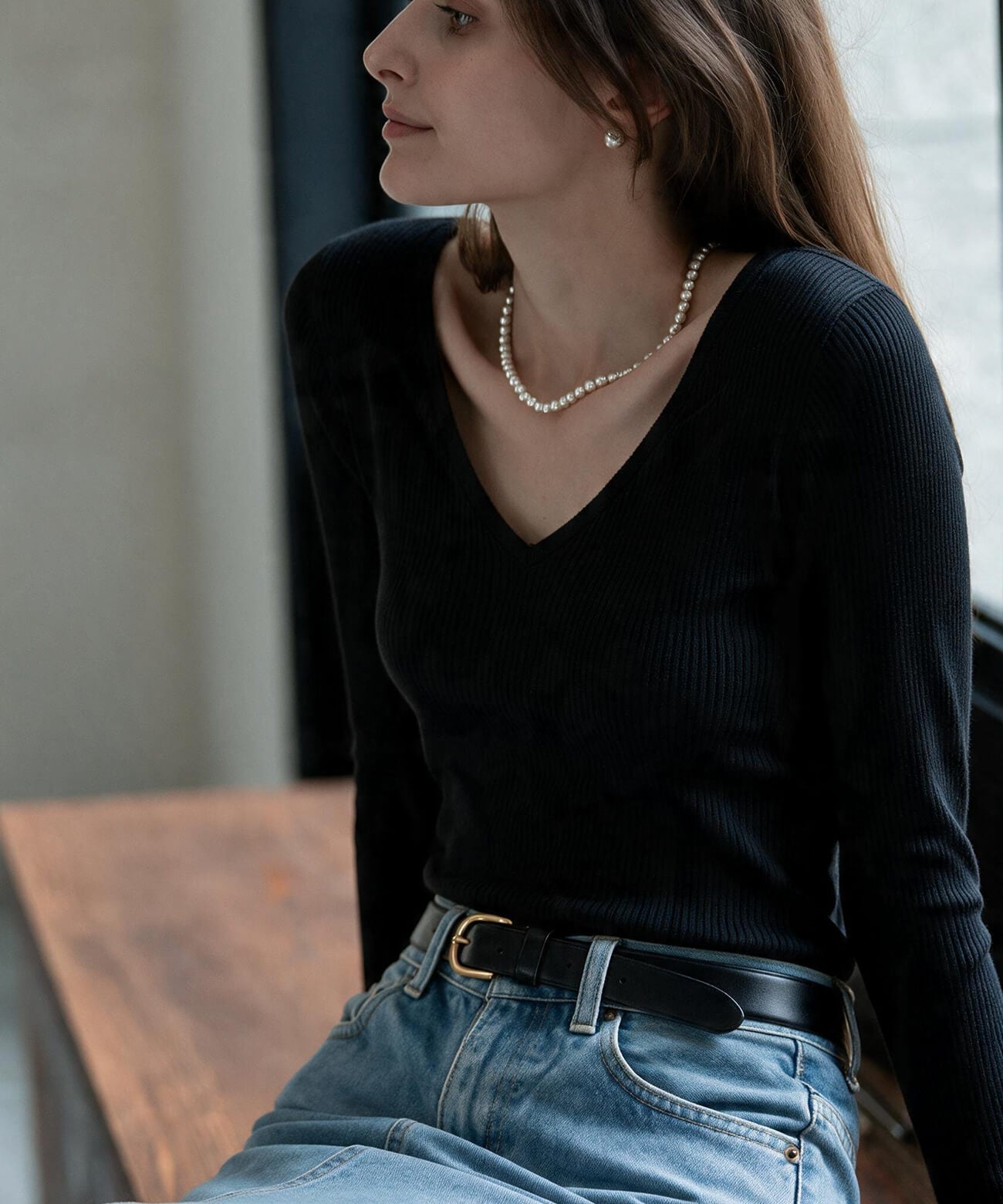 Sterling silver ball chain necklace with a black knit top