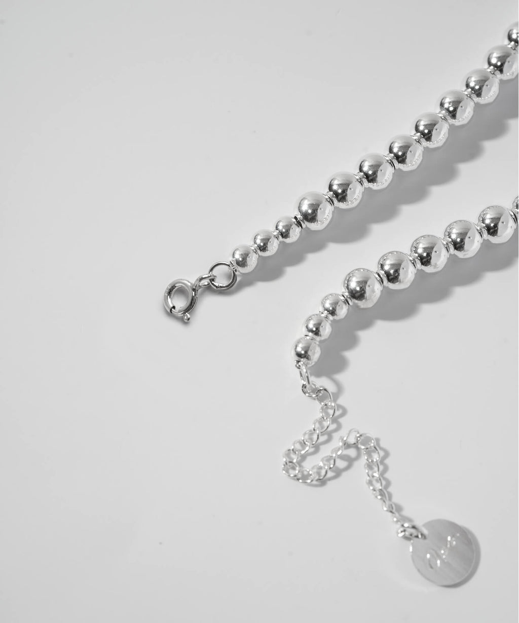 Adjuster chain and logo tag detail