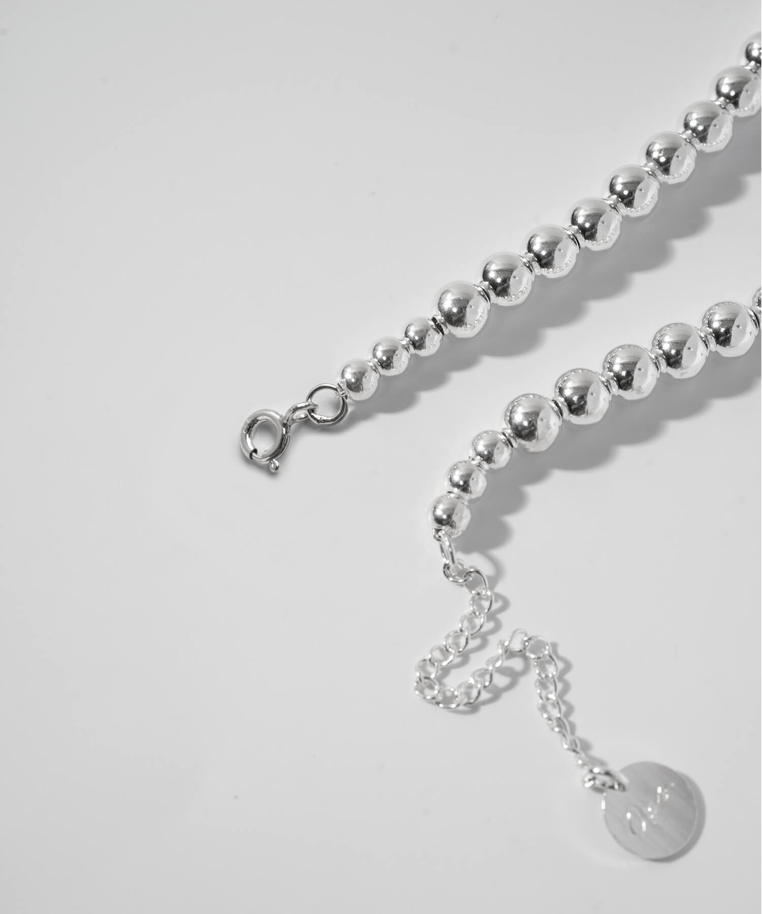 Adjuster chain and logo tag detail
