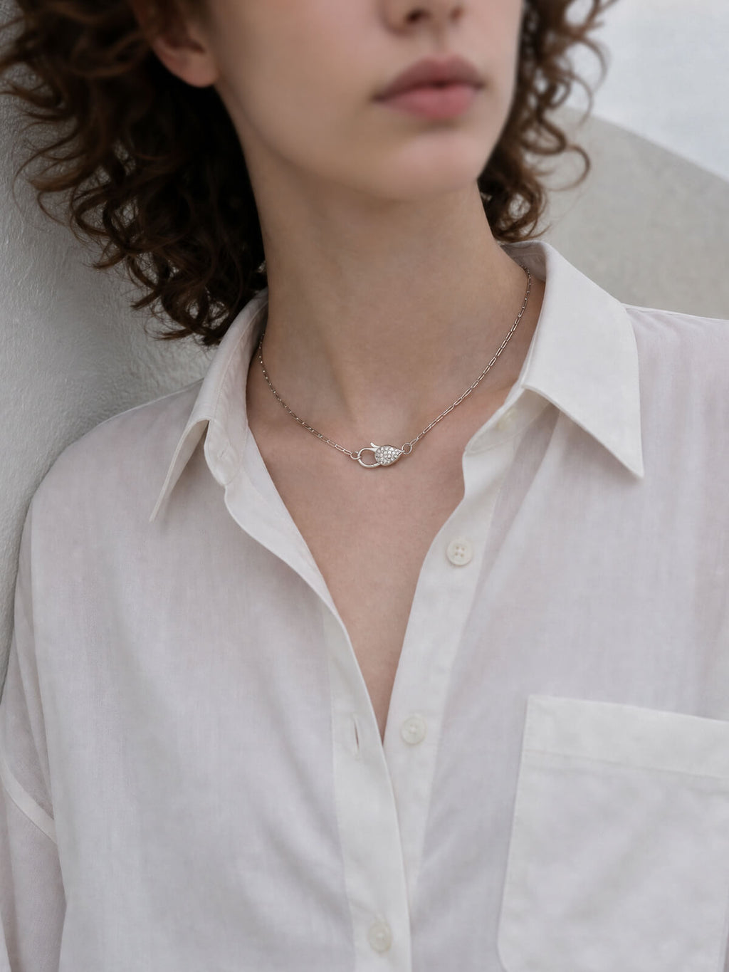 Silver paperclip chain choker necklace worn with a shirt