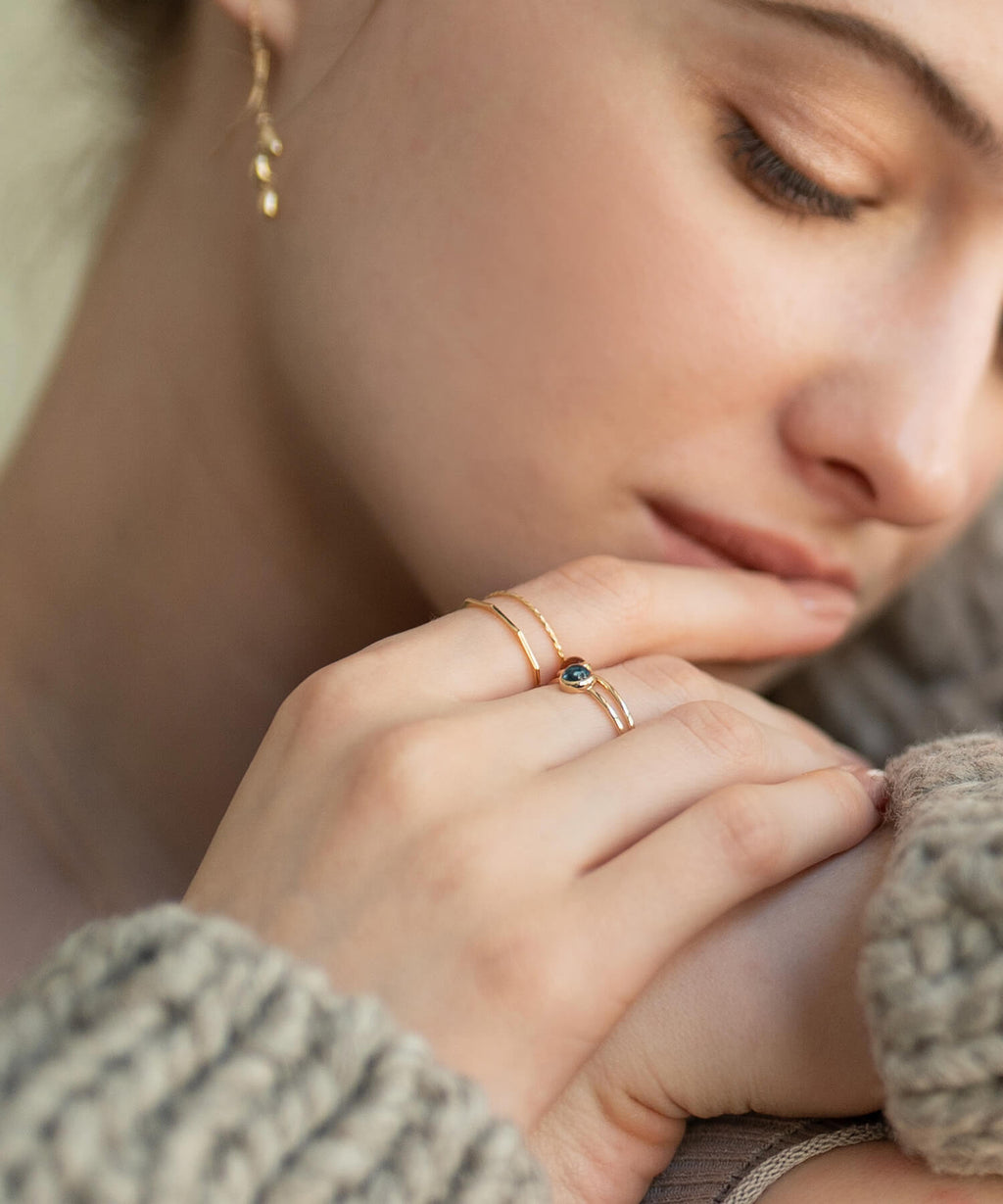 18K gold decagon skinny ring worn with the hand at the chin