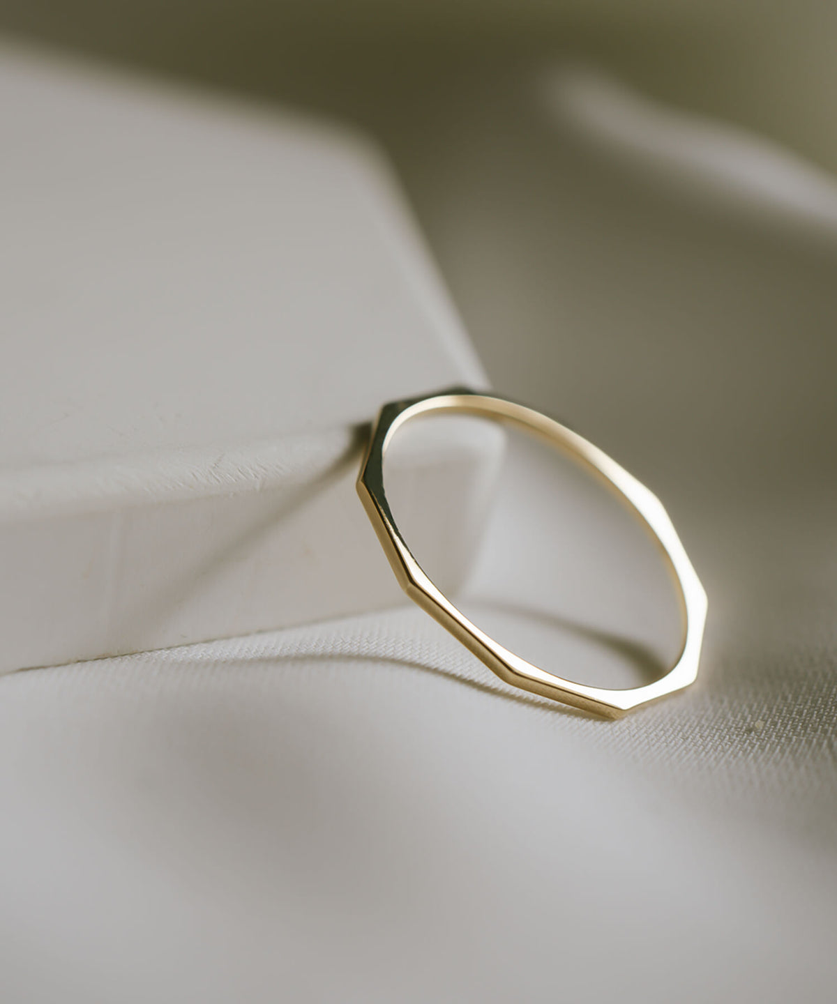 The ten flat facets of the 18K gold skinny ring